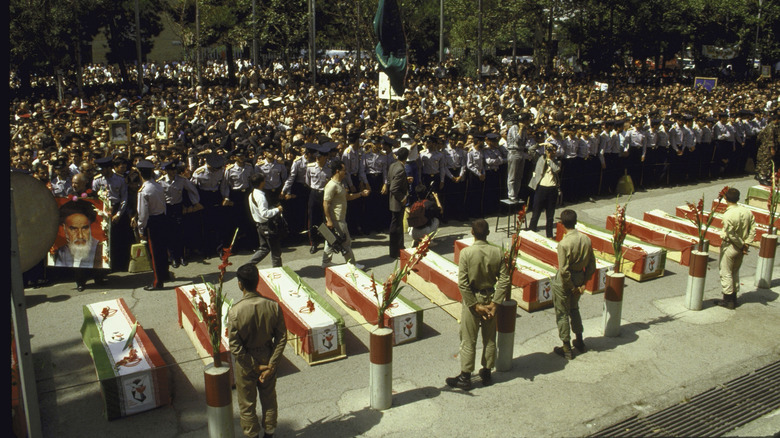caskets of those killed in the attack during public mourning in iran