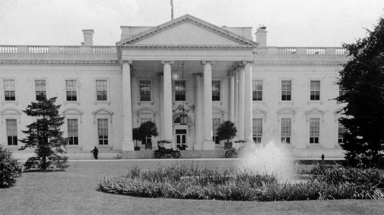 White House with old car out front