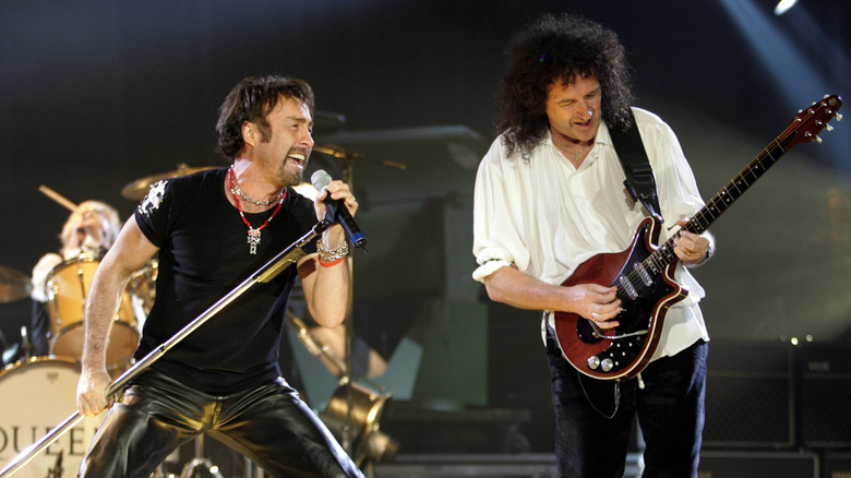 Paul Rodgers performing onstage with Brian May