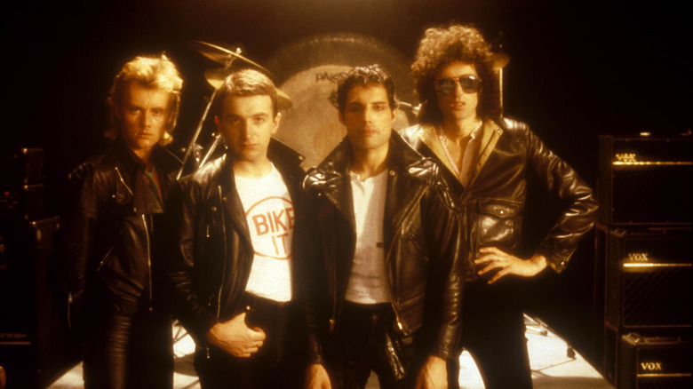 All four members of queen wearing black motorcycle jackets