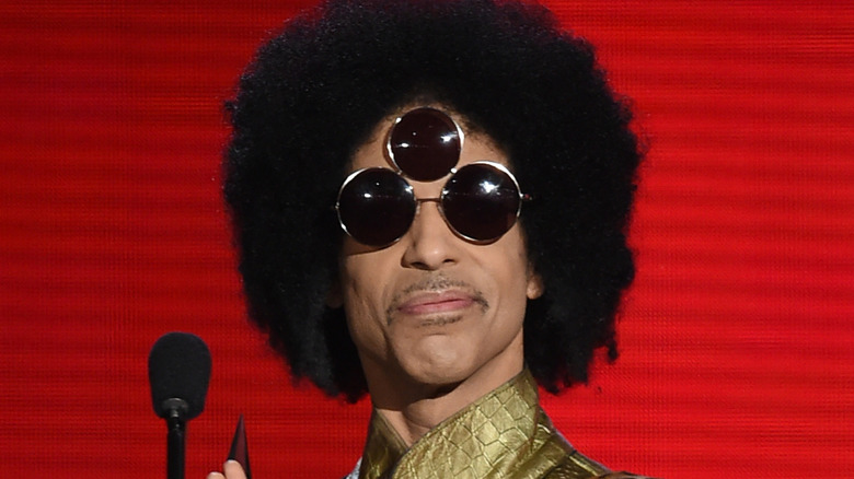 Prince wearing sunglasses with three sets of lenses