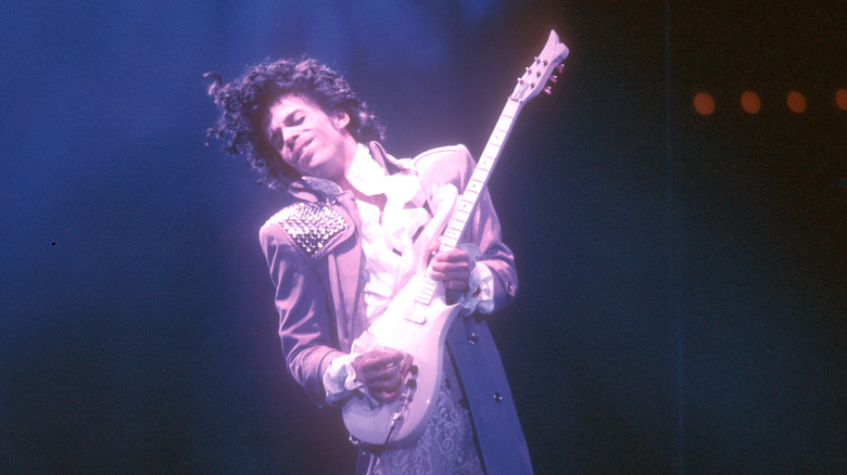Prince playing a guitar solo in concert