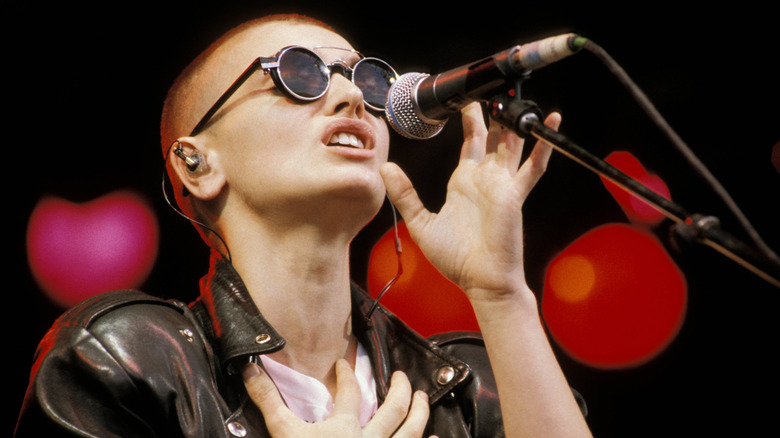 Sinead O'Connor wearing glasses while performing onstage
