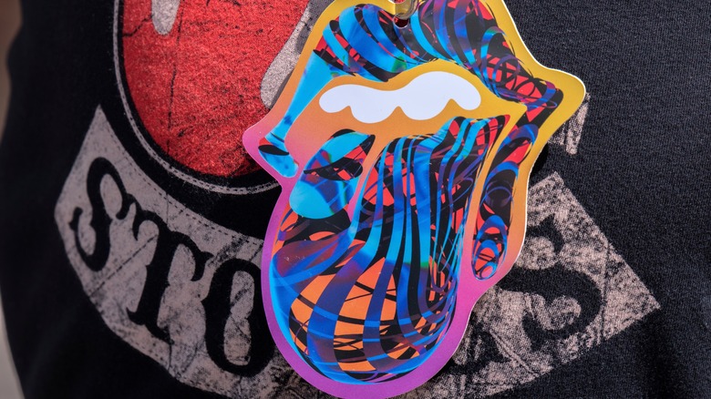 Multi-colored Rolling Stones logo with partial red logo and Stones name