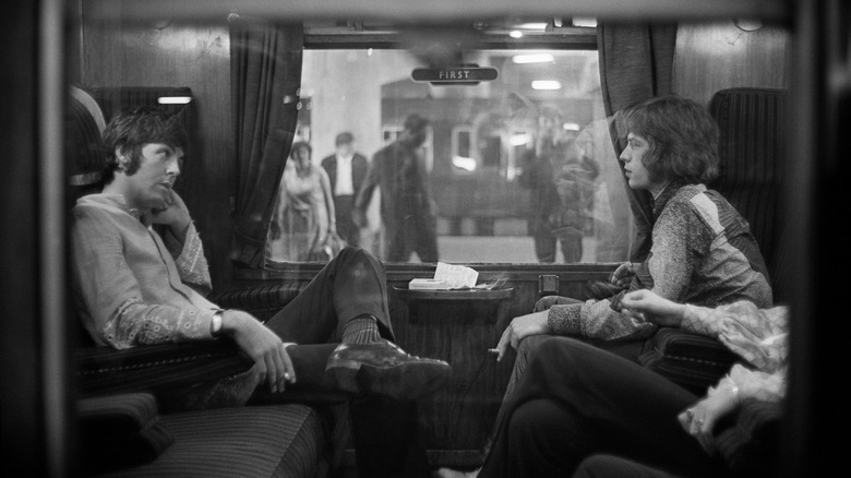 Mick Jagger and Paul McCarrtney on a train
