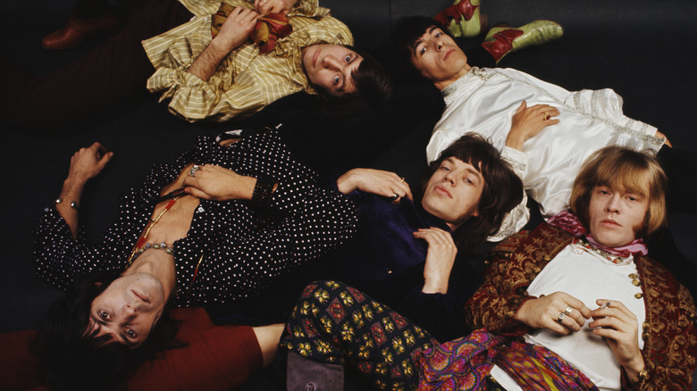 Group photo of the Rolling Stones laying on the floor