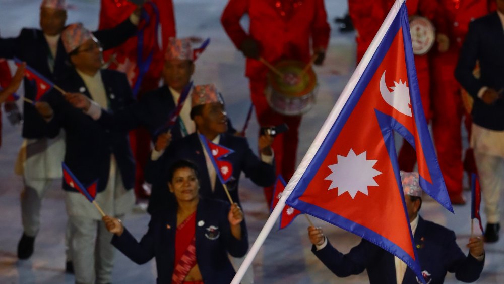 A photograph of Nepal's flag against a blue sky.