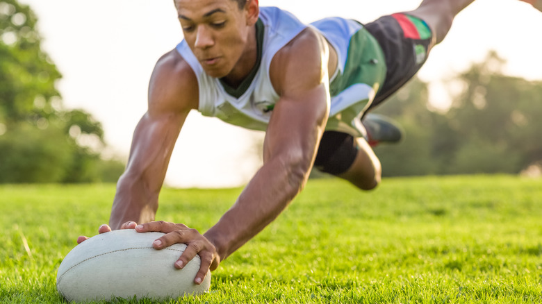 Player diving for rugby ball