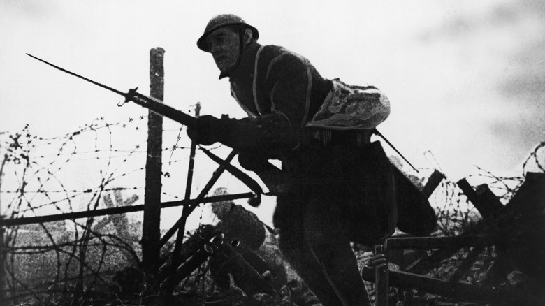 Soldier with bayonet in No Man's Land during WWI