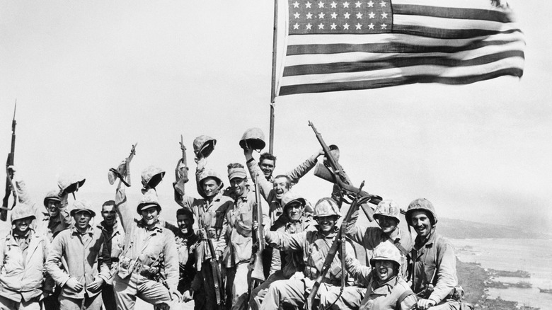 Marines standing next to flag WWII