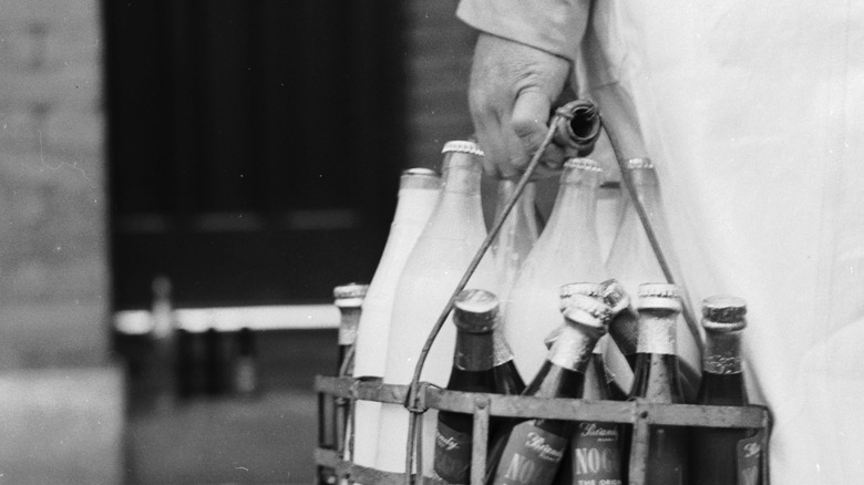 man carrying Milk delivery bottles