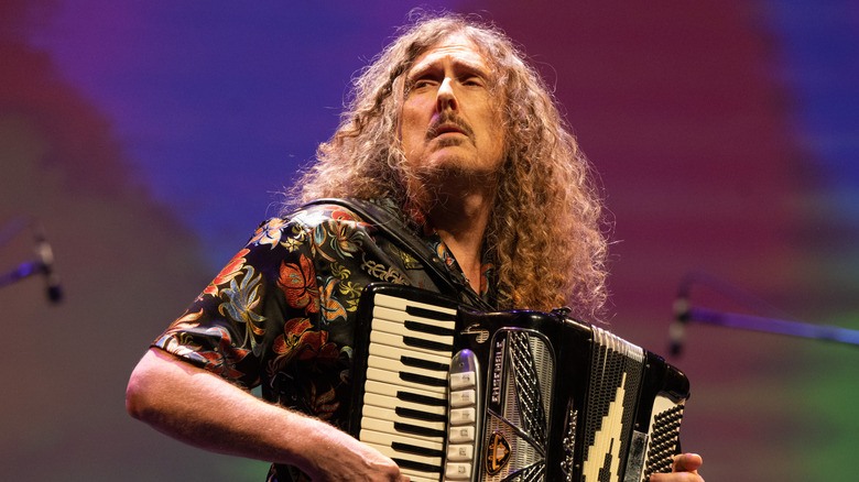 Weird Al Yankovic playing accordion on stage
