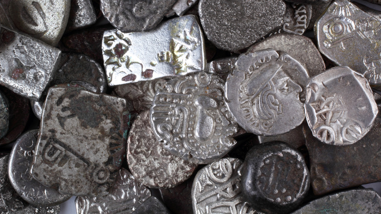Jumble of old silver coins closeup