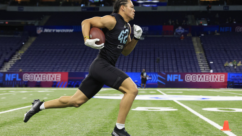 player running with football NFL Combine