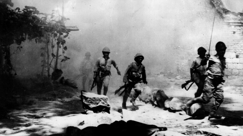 Japanese soldiers running during a battle in China