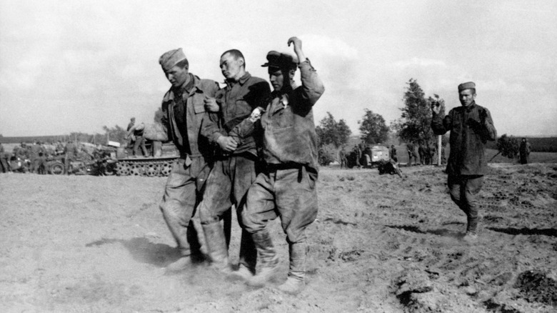 Soviet POWs being escorted by German soldiers