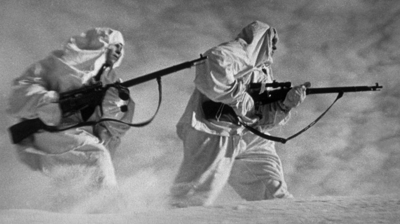 Soviet snipers in white uniforms during a blizzard