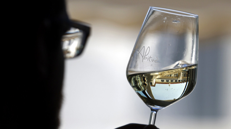 oenologist tests white wine