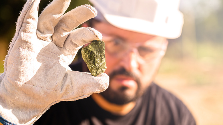 Miner holding gold nugget