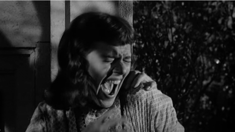 A woman screams as a hand grabs her shoulder in "Macabre."