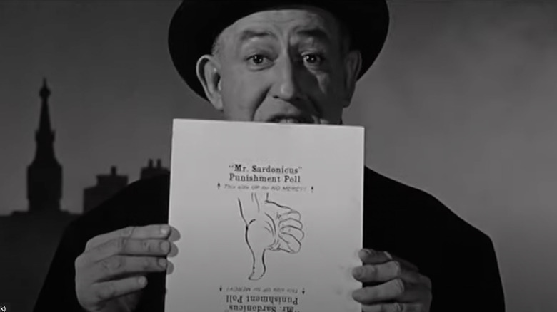 William Castle holds up the "Mr. Sardonicus" Punishment Poll