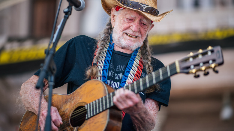 Willie Nelsom playing his guitar Trigger