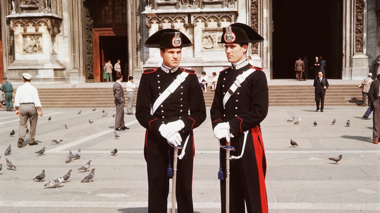 Two italian carabinieri policemen in uniform in front of steps