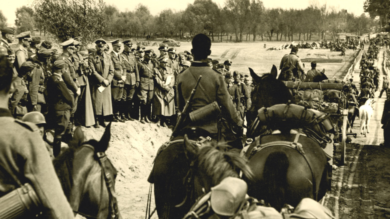 hitler watching his troops leave on the way to poland