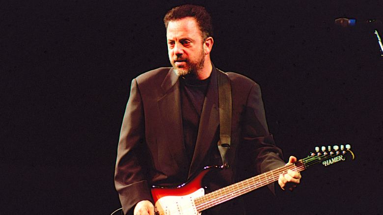Billy Joel playing a guitar circa the '80s