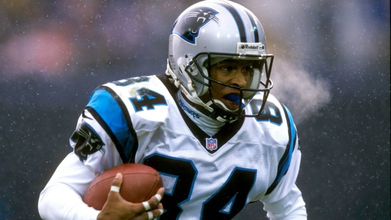 Rae Carruth running with football