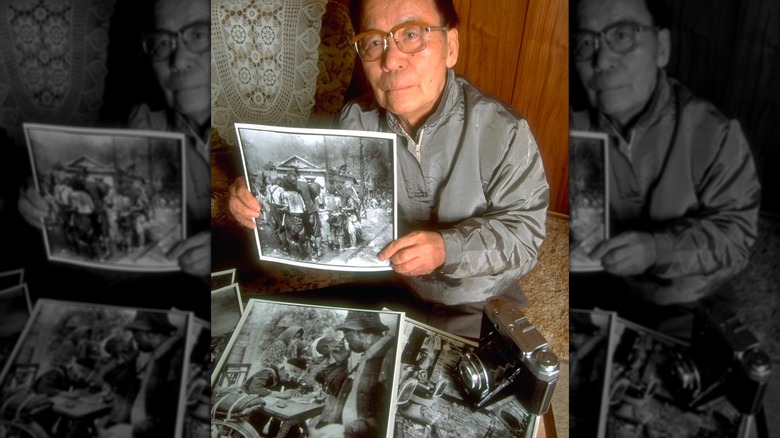 Yoshito Matsushige with the photos he took of atomc bomb aftermath