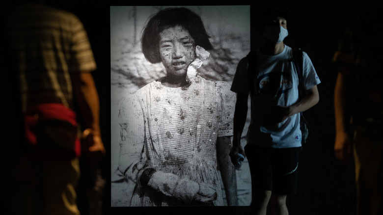 Photo of a 10-year-old atomic bomb survivor projected on the wall