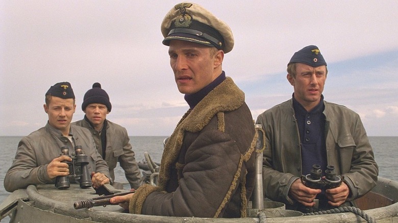 Matthew McConaughey and other cast members in WWII uniforms looking out of submarine hatch