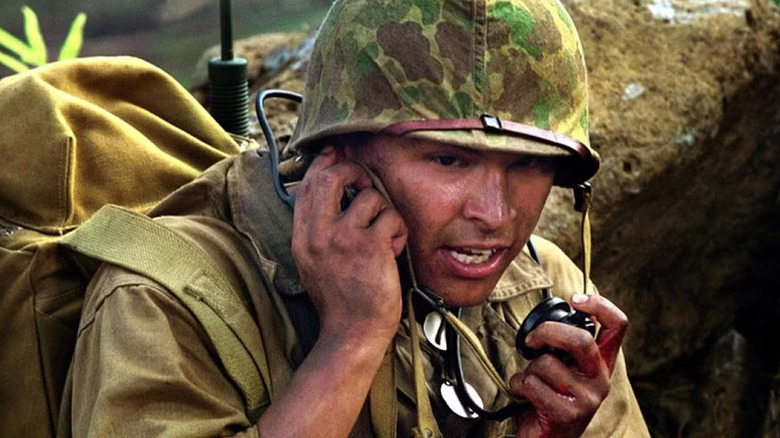 Actor Adam Beach as code talker speaking into radio
