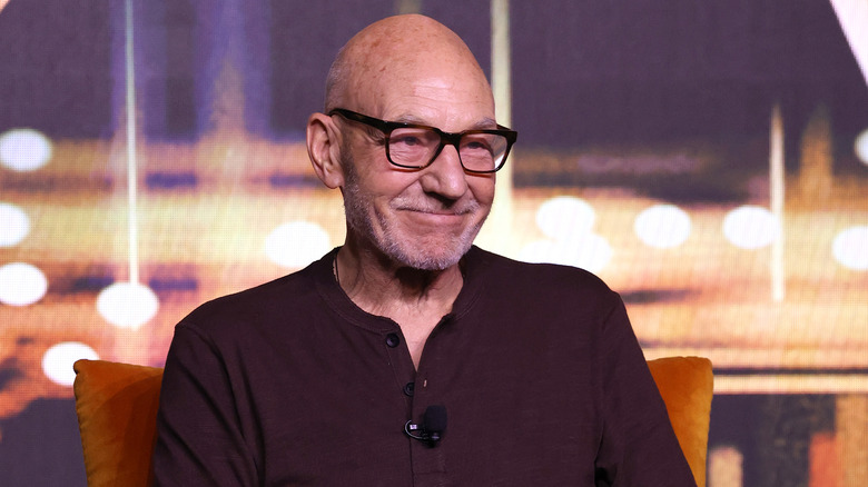 Patrick Stewart wearing glasses and smiling