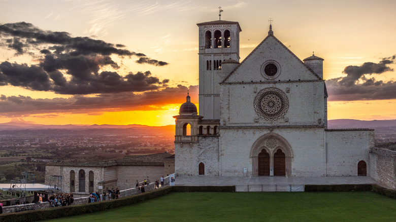 Exterior view of Basilica of St. Francis of Assisi with low sun in background