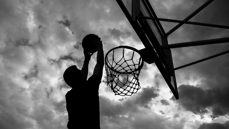 silhouette of man playing basketball
